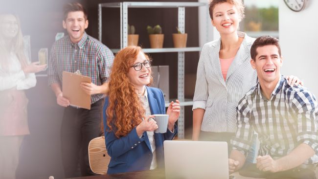 The photo shows a group of employees enjoying spending time together at work.